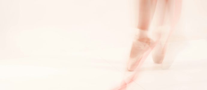 a blurred image of a ballerina's legs