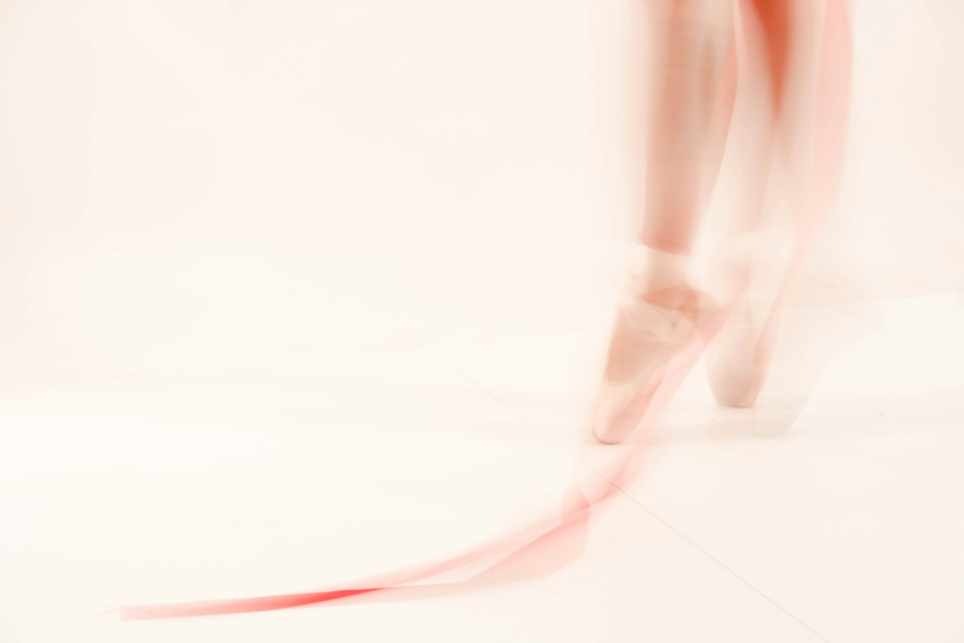 a blurred image of a ballerina's legs