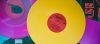 A bright yellow vinyl record on top of purple records