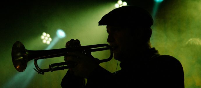 Silhouette of a man playing a trumpet