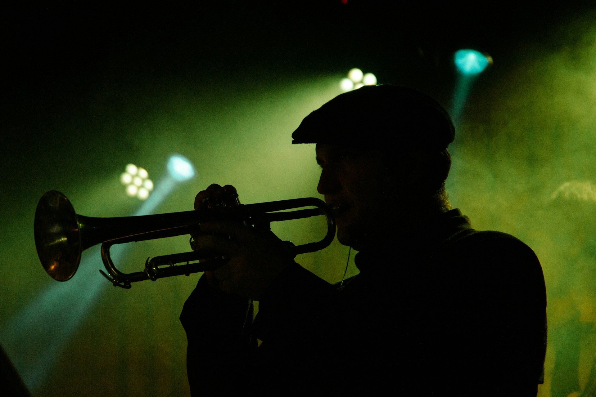 Silhouette of a man playing a trumpet