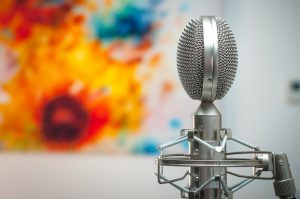 A microphone in front of a colourful painting