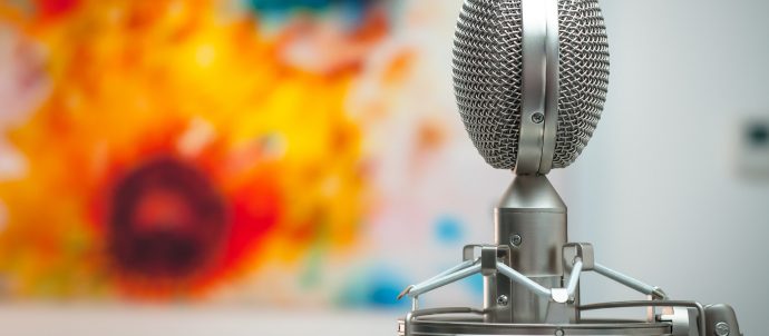 A microphone in front of a colourful painting