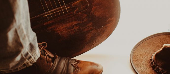 Close up of a boot, instrument and hat